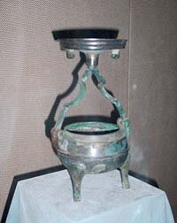 bronze lantern shaped in an ancient cooking vessel